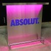 Custom branded DELUX portable bar with ABSOLUT vodka logo in matching Pantone color, pink lights on.
