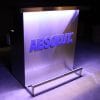 Custom branded DELUX portable bar with ABSOLUT vodka logo in matching Pantone color, white and light blue lights on.