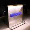 Custom branded DELUX portable bar with ABSOLUT vodka logo in matching Pantone color, white lights on.