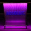 Custom branded DELUX portable bar with ABSOLUT vodka logo in matching Pantone color, dark pink lights on.